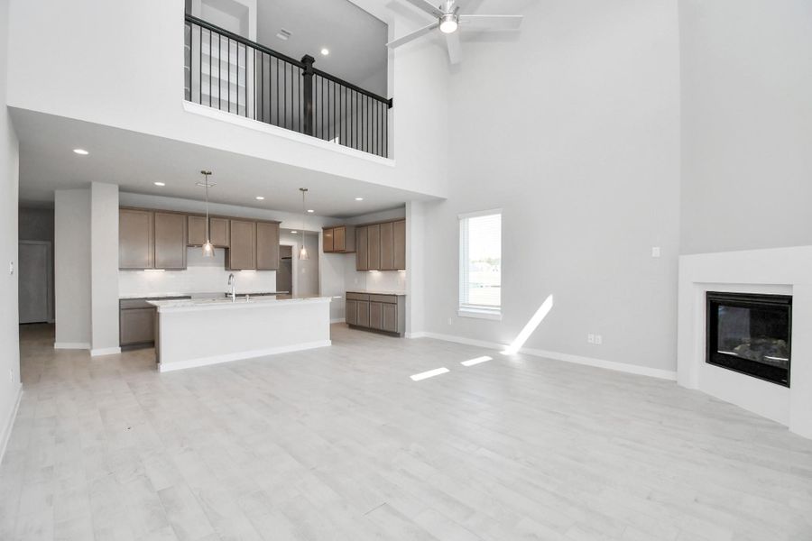 Welcome family and guests to your charming living room! With its high ceilings, recessed lighting, ceiling fan, custom paint, beautiful flooring, and large windows that let in abundant natural light, this room is perfect for gatherings. Sample photo of completed home with similar floor plan. Actual colors and selections may vary. Welcome family and guests to your charming living room! With its high ceilings, recessed lighting, ceiling fan, custom paint, beautiful flooring, and large windows that let in abundant natural light, this room is perfect for gatherings. Sample photo of completed home with similar floor plan. Actual colors and selections may vary.