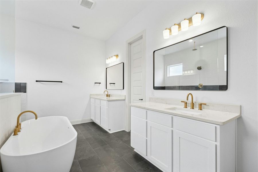 Bathroom with a freestanding tub, two vanities, and a walk in shower Bathroom with a freestanding tub, two vanities, and a walk in shower
