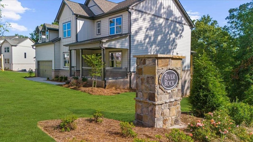 Front exterior of a new home in River Rock, Ball Ground, GA, highlighting curb appeal (Image 1).