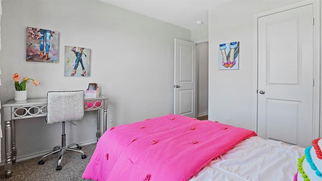 Neutral wall paint, textured carpet flooring, and white interior doors