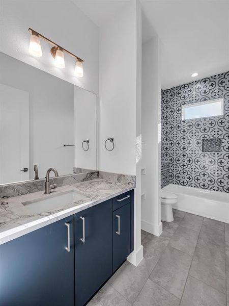 Bathroom with vanity, toilet, and a bathtub