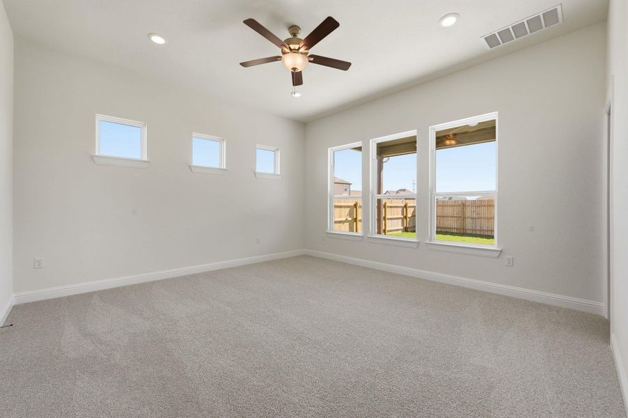 Spare room featuring light colored carpet, ceiling fan, and recessed lighting