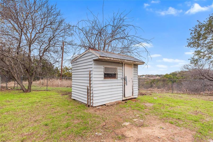 View of shed with a fenced backyard
