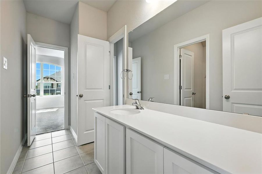 Bathroom featuring vanity and light tile patterned floors