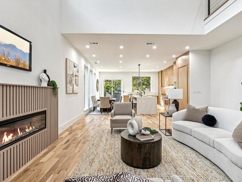 Living room with light wood-type flooring and sink