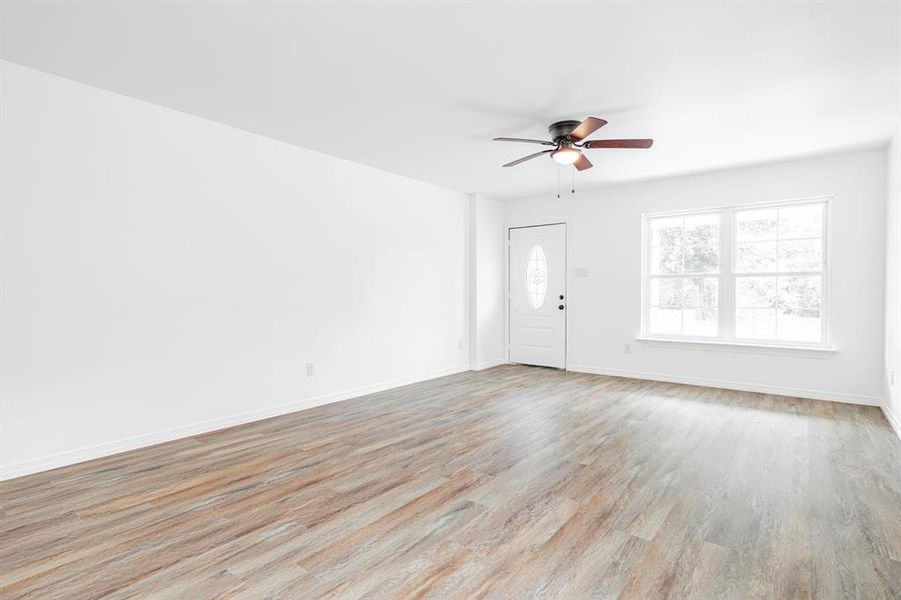 Empty room featuring light hardwood / wood-style floors and ceiling fan