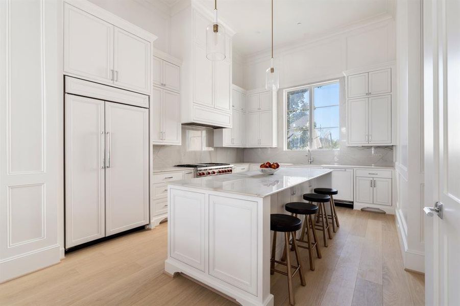 No detail is overlooked in the kitchen design, from the floor-to-ceiling double stacked cabinetry to the 10' island, every facet construction is well-planned and deliberate, a result of decades of stellar construction. (photo of interior model home with smaller floor plan)