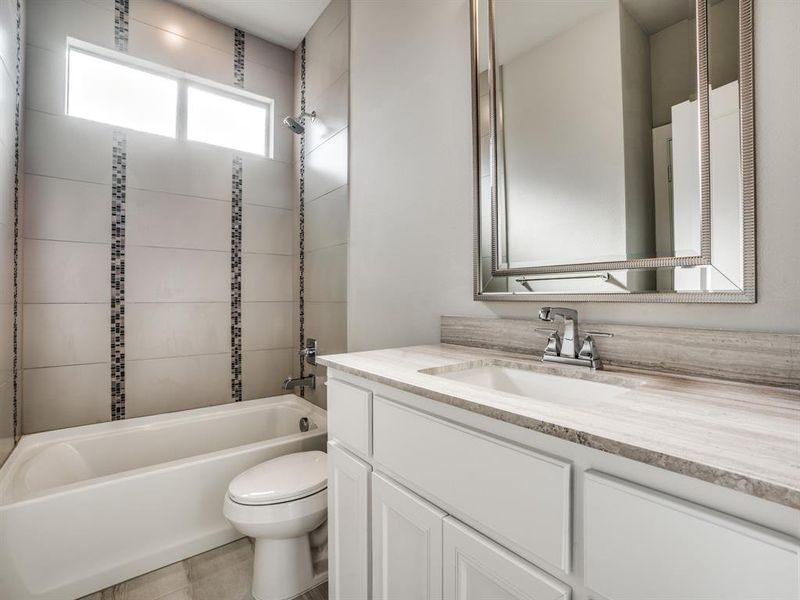 Full bath with vanity, bathing tub / shower combination, and toilet