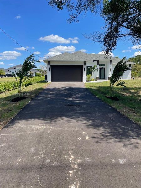 Front exterior of a new home in , Naples, FL, highlighting curb appeal (Image 18). Front exterior of a new home in , Naples, FL, highlighting curb appeal (Image 18).