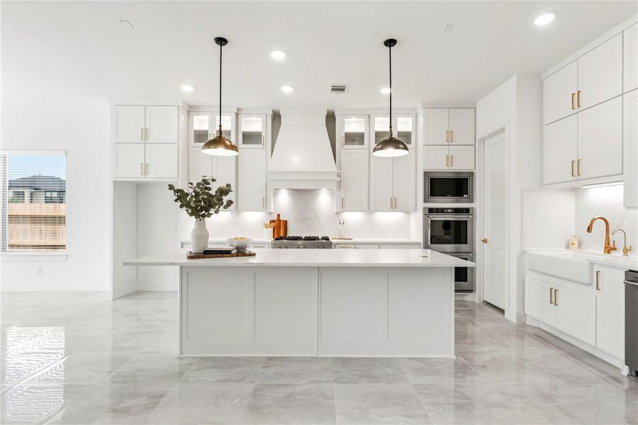 A culinary masterpiece awaits in this chef-inspired kitchen, featuring pristine quartz countertops, high-end double ovens, custom soft-closing cabinetry, and exquisite under-cabinet lighting.