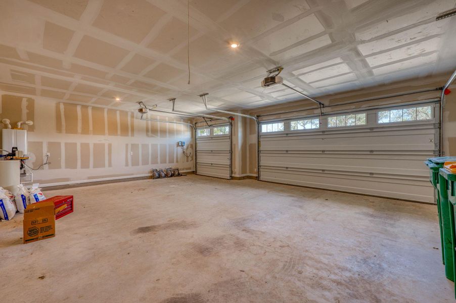 An expansive multi-car garage provides substantial space with concrete flooring and overhead storage potential.