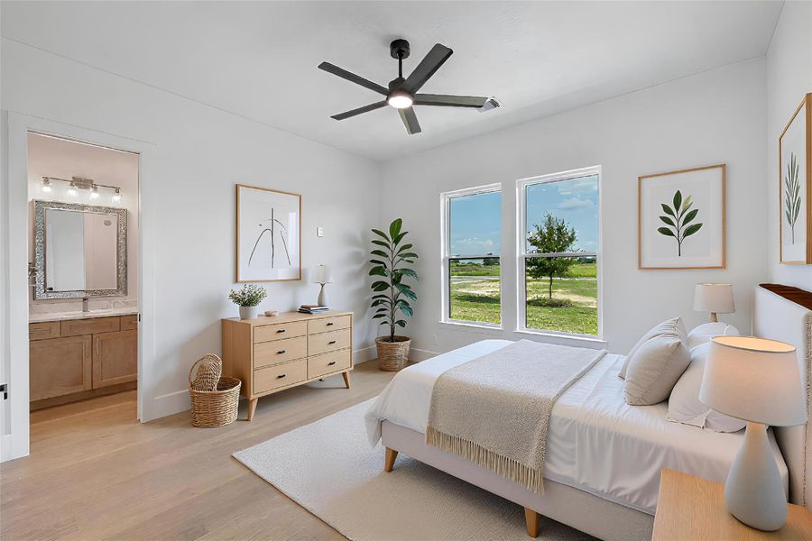 Bedroom featuring light wood finished floors, a ceiling fan, and connected bathroom