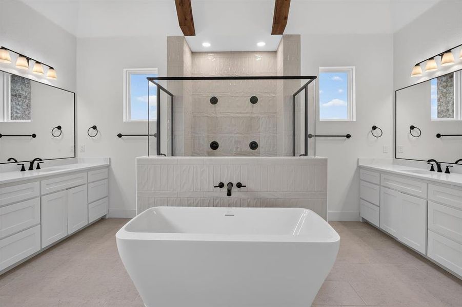 Freestanding soaking tub centered in a spacious bathroom Freestanding soaking tub centered in a spacious bathroom