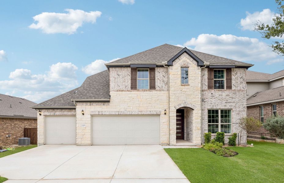 Front exterior of a new home in Crescent Bluff, Georgetown, TX, highlighting curb appeal (Image 18).