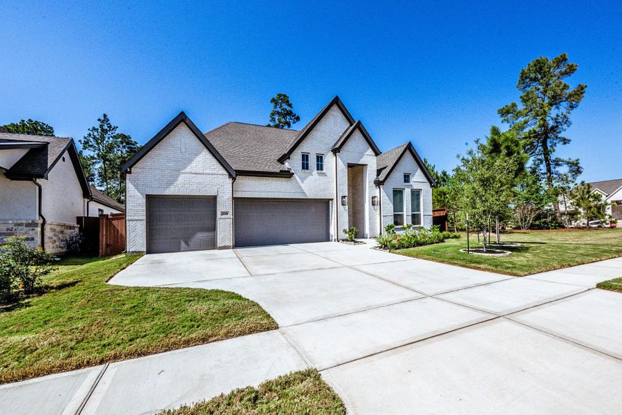 Front exterior of a new home in , Conroe, TX, highlighting curb appeal (Image 21).