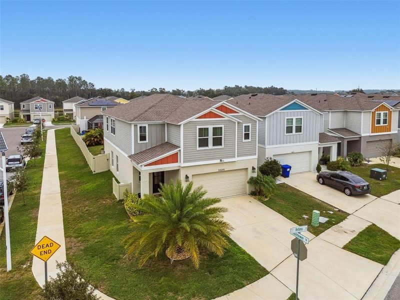 Front exterior of a new home in Pasadena Point, Wesley Chapel, FL, highlighting curb appeal (Image 1).