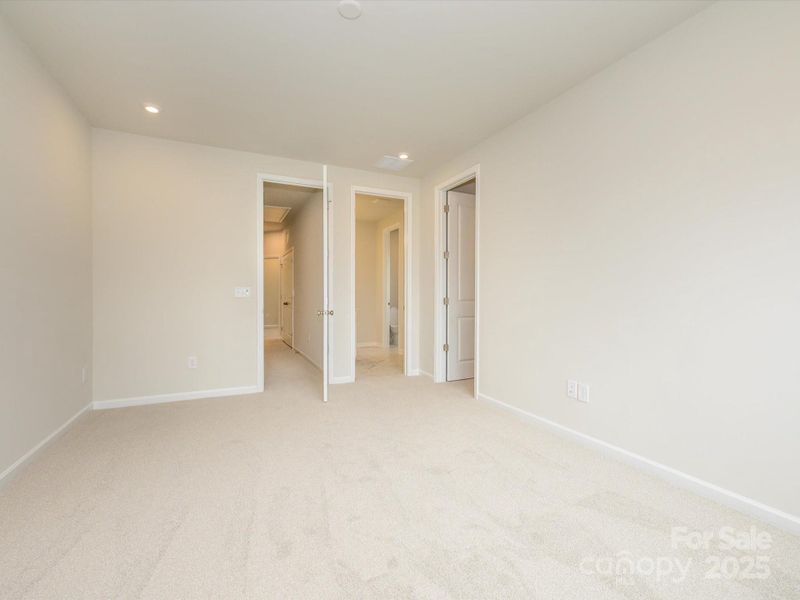 Primary suite with walk-in closet and en suite bath. Primary suite with walk-in closet and en suite bath.