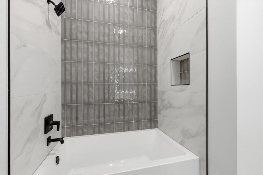 An alcove tub with luxurious finishes.