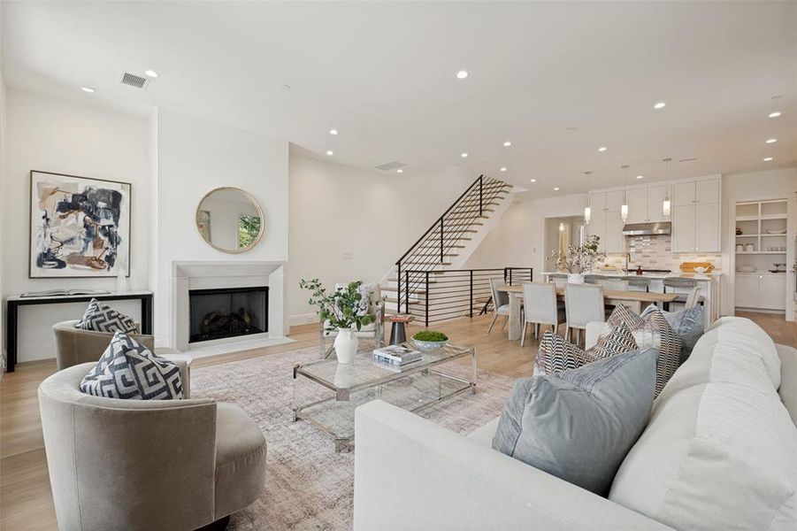 The spacious second floor is the heart of the home, featuring a centrally located living area with a fireplace, dining space, kitchen with pantry, powder room, and primary suite. The spacious second floor is the heart of the home, featuring a centrally located living area with a fireplace, dining space, kitchen with pantry, powder room, and primary suite.