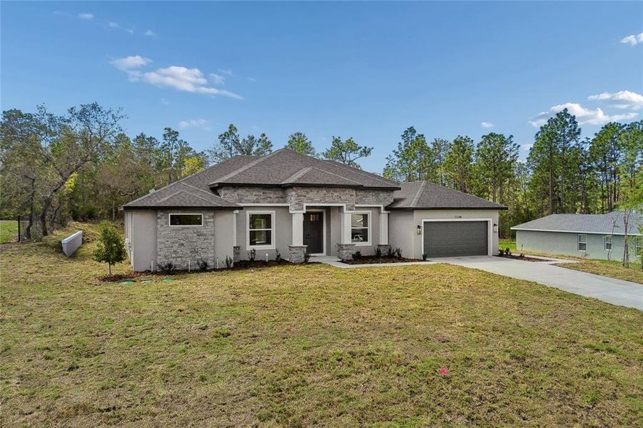 Front exterior of a new home in , Weeki Wachee, FL, highlighting curb appeal (Image 29). Front exterior of a new home in , Weeki Wachee, FL, highlighting curb appeal (Image 29).