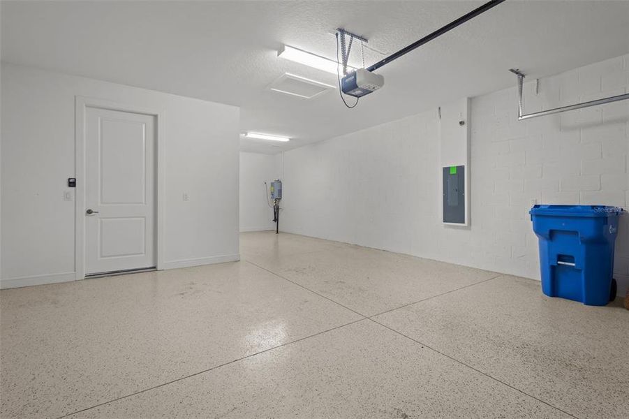 Garage - epoxy flooring, tandem garage parking perfect for a golf cart or storage, tankless water heater