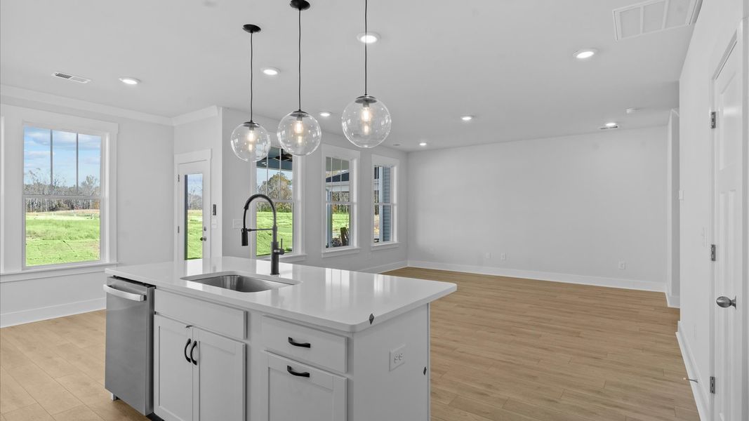 First-rate kitchen with functional layout, designer pendant lighting, and a large center island