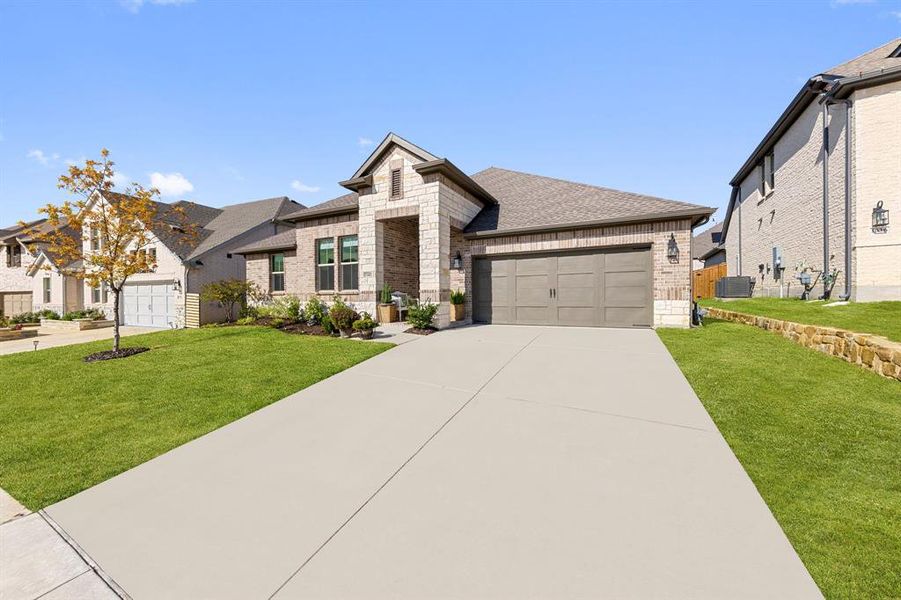 Front exterior of a new home in Monterra, Fate, TX, highlighting curb appeal (Image 1).