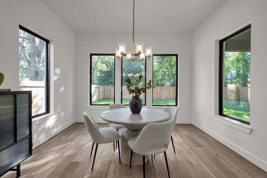 Breakfast nook surrounded by large windows overlooking the backyard. Breakfast nook surrounded by large windows overlooking the backyard.