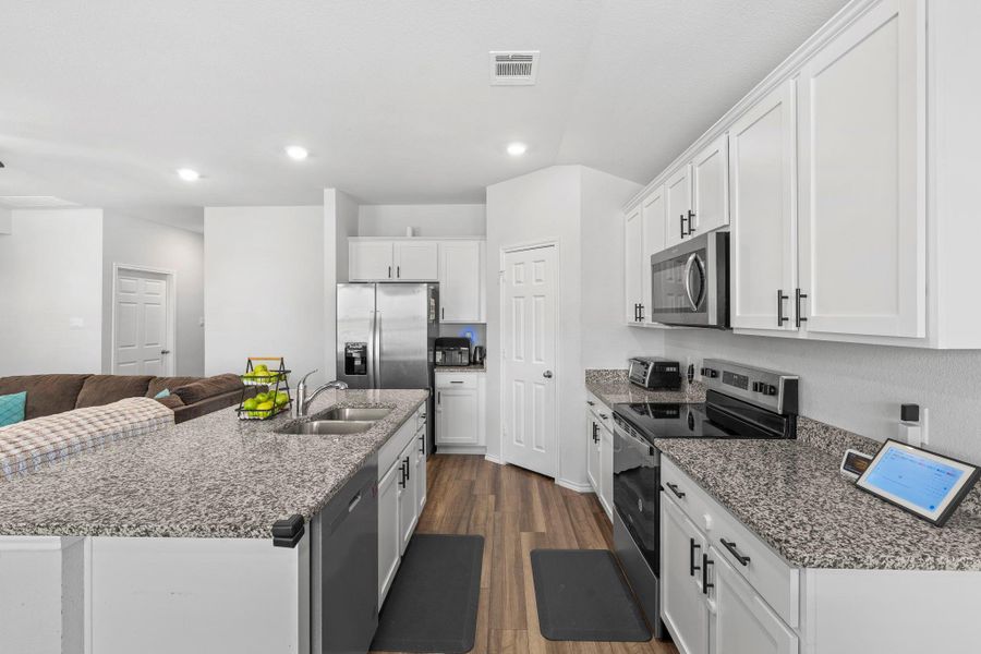 Granite counters and stainless steel appliances create a sophisticated and highly functional kitchen. Granite counters and stainless steel appliances create a sophisticated and highly functional kitchen.