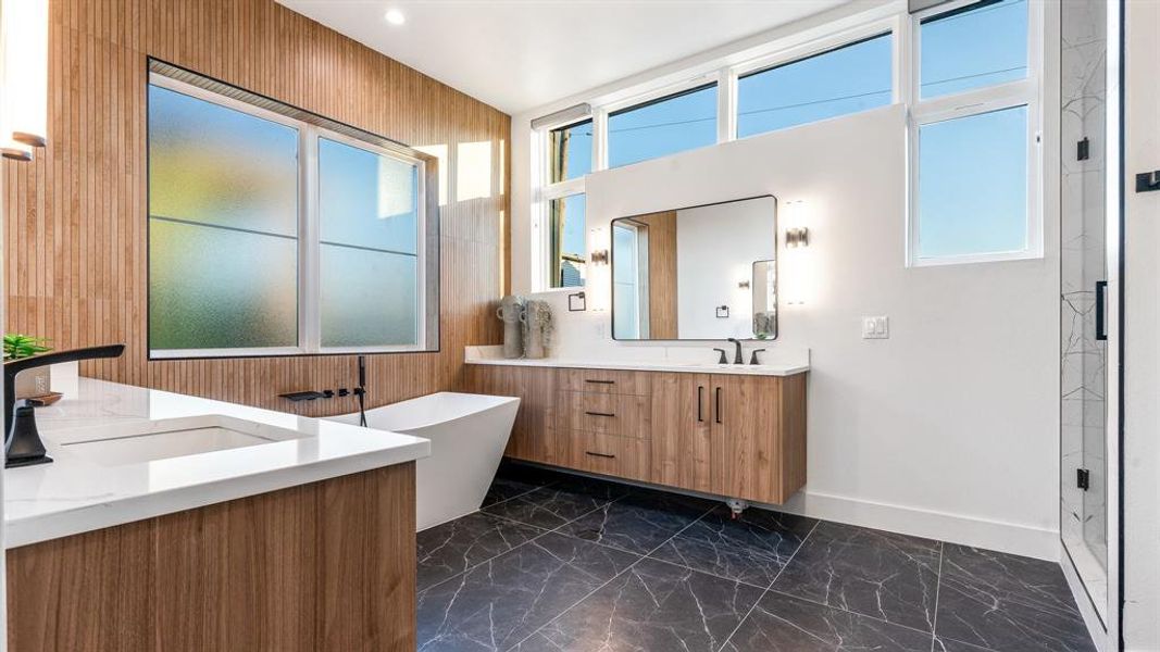 Bathroom featuring dual vanity, shower with separate bathtub, and tile floors