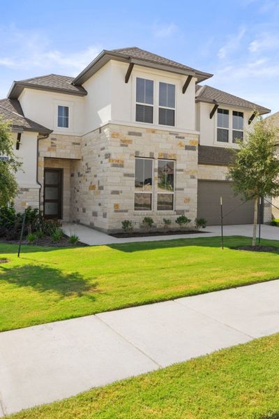 Front exterior of a new home in Lariat, Liberty Hill, TX, highlighting curb appeal (Image 29).