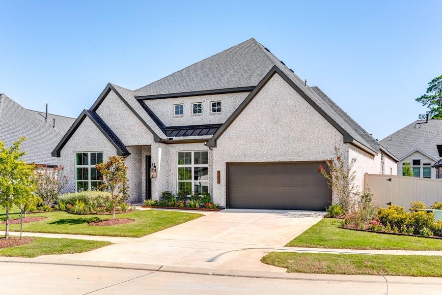 Front exterior of a new home in Audubon 60′, Magnolia, TX, highlighting curb appeal (Image 2). Front exterior of a new home in Audubon 60′, Magnolia, TX, highlighting curb appeal (Image 2).
