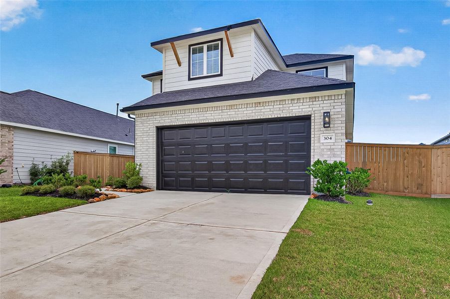 Front exterior of a new home in La Segarra, Brookshire, TX, highlighting curb appeal (Image 21). Front exterior of a new home in La Segarra, Brookshire, TX, highlighting curb appeal (Image 21).