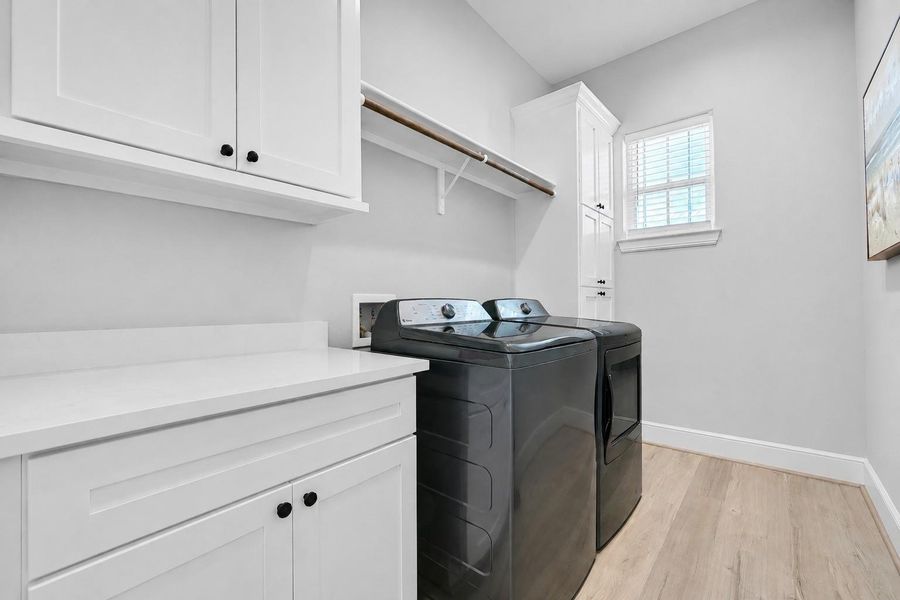 The main floor utility room offers built in storage, workspace, and everyday convenience tucked neatly away from the main living areas.