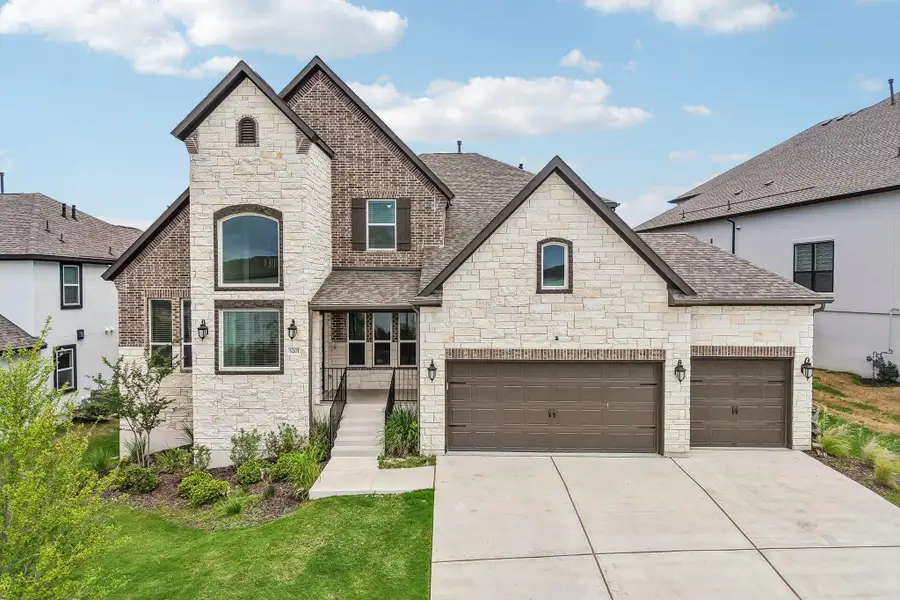 An inviting stone and brick façade welcomes you home to this elegant residence.