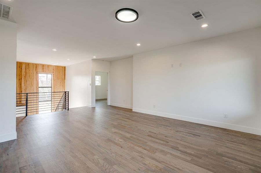 Empty room featuring wood finished floors, recessed lighting, and wooden walls Empty room featuring wood finished floors, recessed lighting, and wooden walls