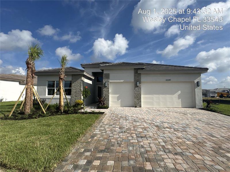 Front exterior of a new home in Valencia Ridge, Wesley Chapel, FL, highlighting curb appeal (Image 1).