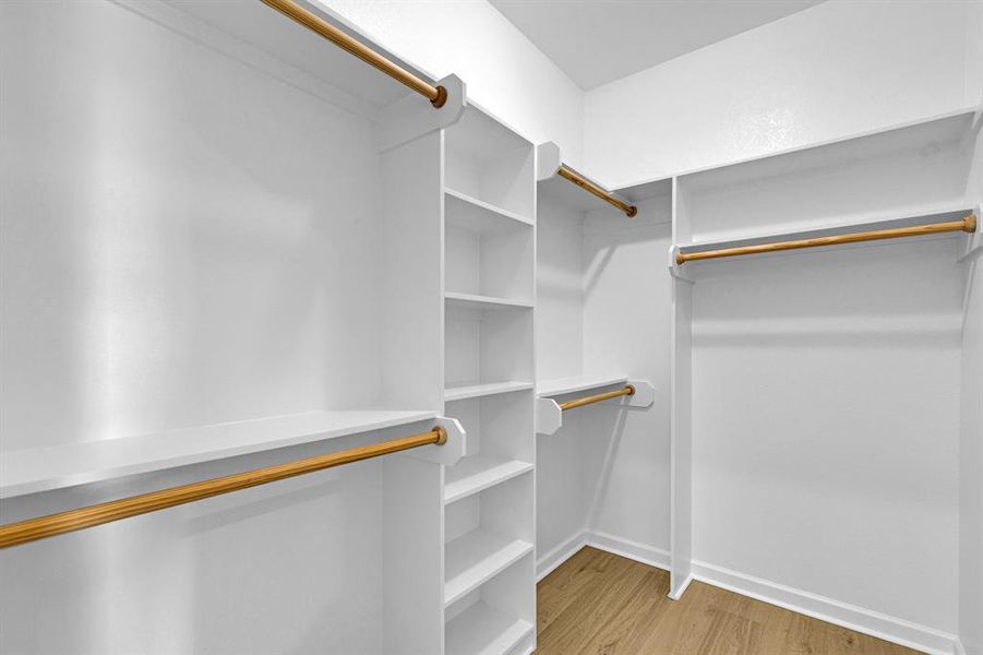 Walk in closet featuring light wood finished floors Walk in closet featuring light wood finished floors