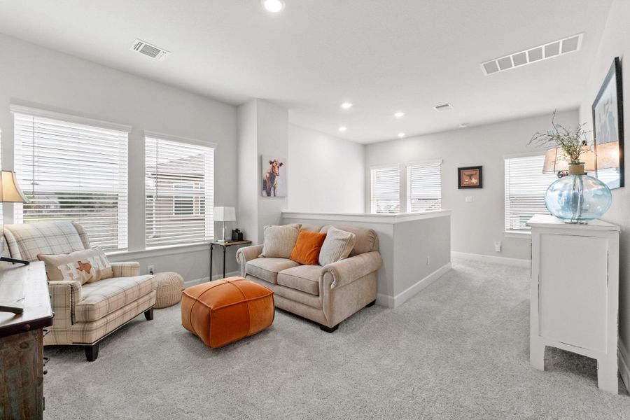 Living room with visible vents, recessed lighting, baseboards, and light carpet Living room with visible vents, recessed lighting, baseboards, and light carpet