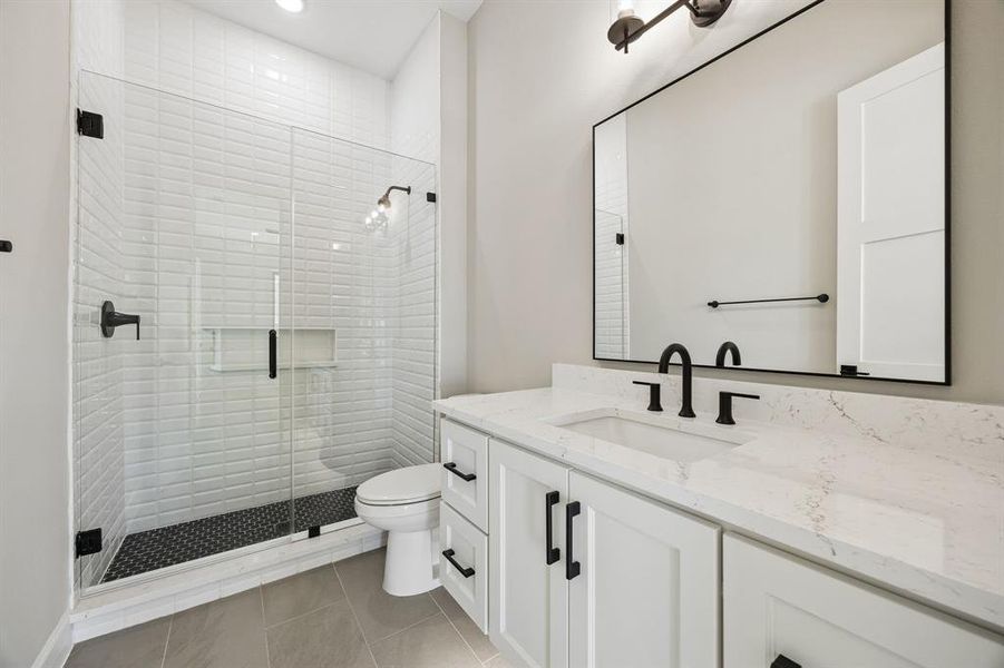 Bathroom with vanity, a stall shower, light tile patterned floors, and recessed lighting Bathroom with vanity, a stall shower, light tile patterned floors, and recessed lighting