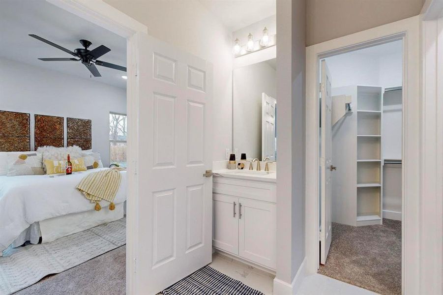 Bathroom with ceiling fan and vanity