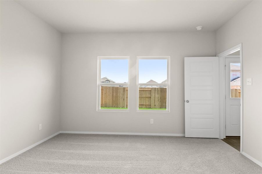 Carpeted empty room with baseboards