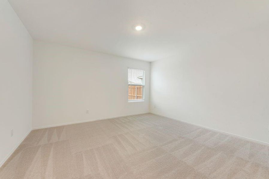 Spare room featuring baseboards and light colored carpet