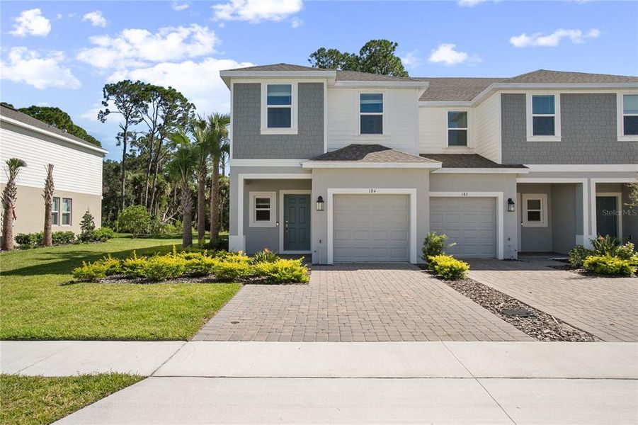Front exterior of a new home in , Edgewater, FL, highlighting curb appeal (Image 16).