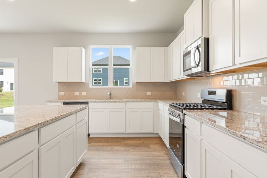 A kitchen with white cabinets. A kitchen with white cabinets.