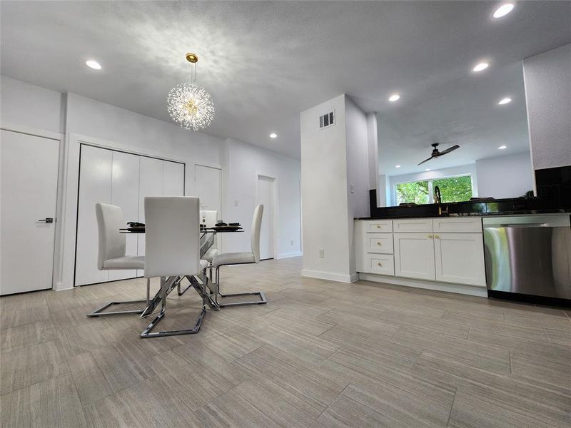 Dining area featuring an inviting chandelier and sink