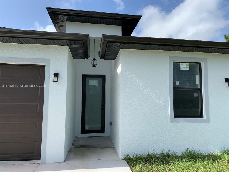 Front exterior of a new home in , Lehigh Acres, FL, highlighting curb appeal (Image 15).