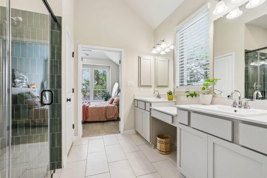 Dual vanities and a spacious shower elevate this primary bathroom.