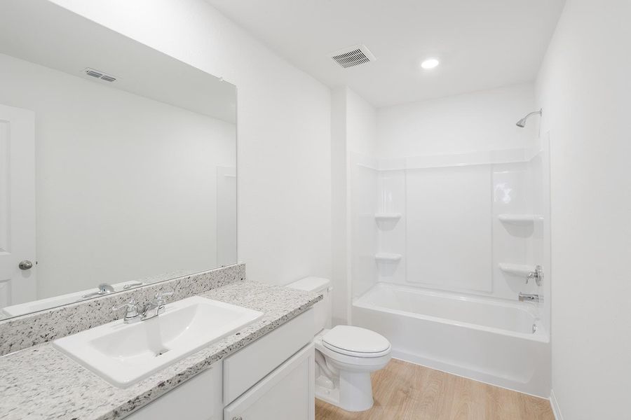 Full bath with light wood-type flooring, shower / bathtub combination, and vanity Full bath with light wood-type flooring, shower / bathtub combination, and vanity