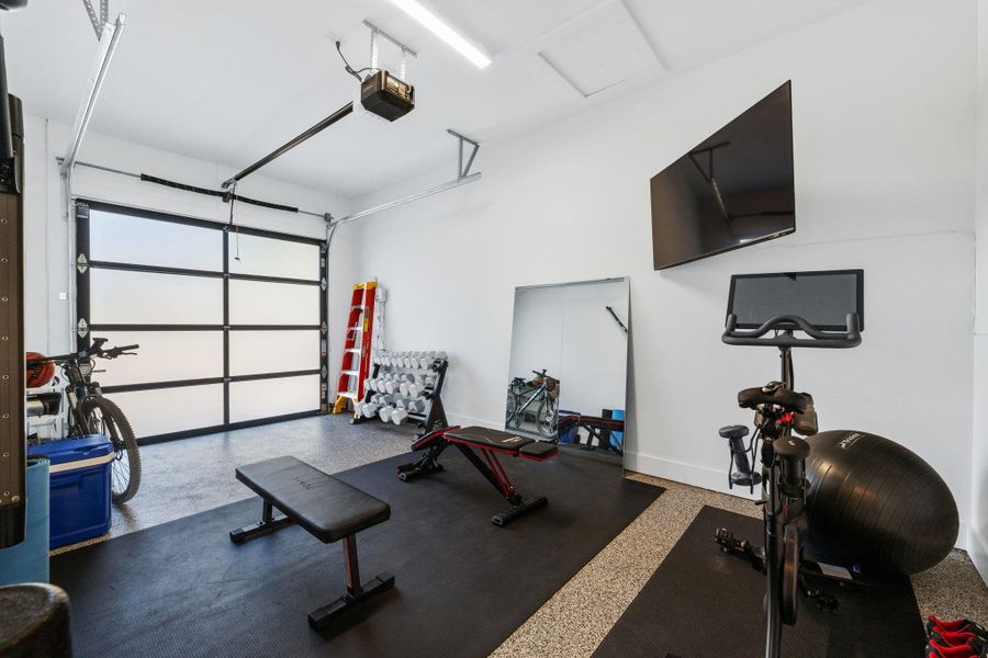 Workout room with a garage and baseboards